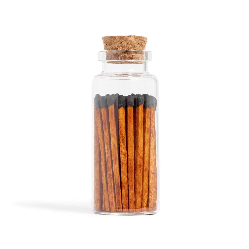 black tip matchsticks with dark wood in corked vial with match striker