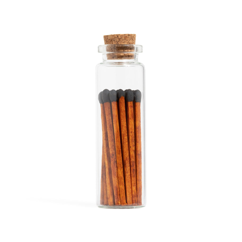 black tip matchsticks with dark wood in corked vial with match striker