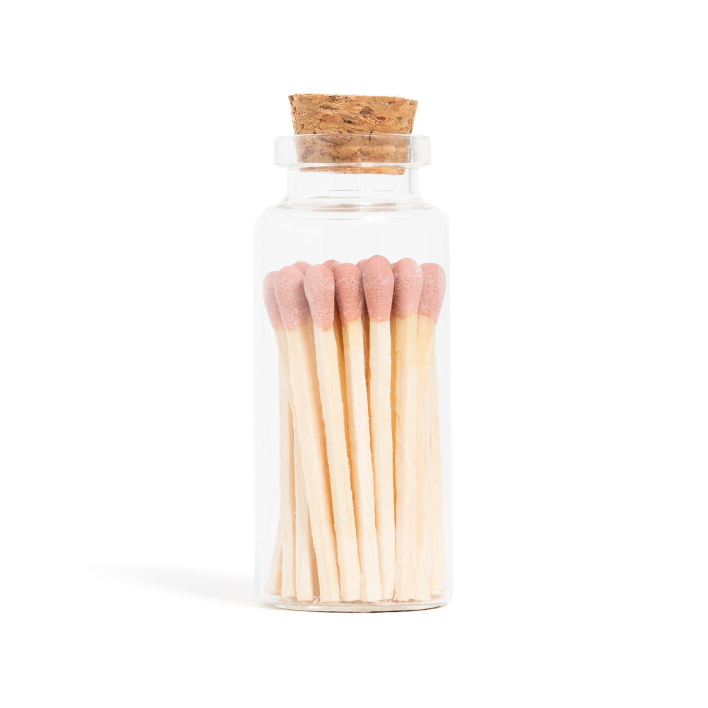 dusty rose color tip wood matchsticks in corked jar with match striker