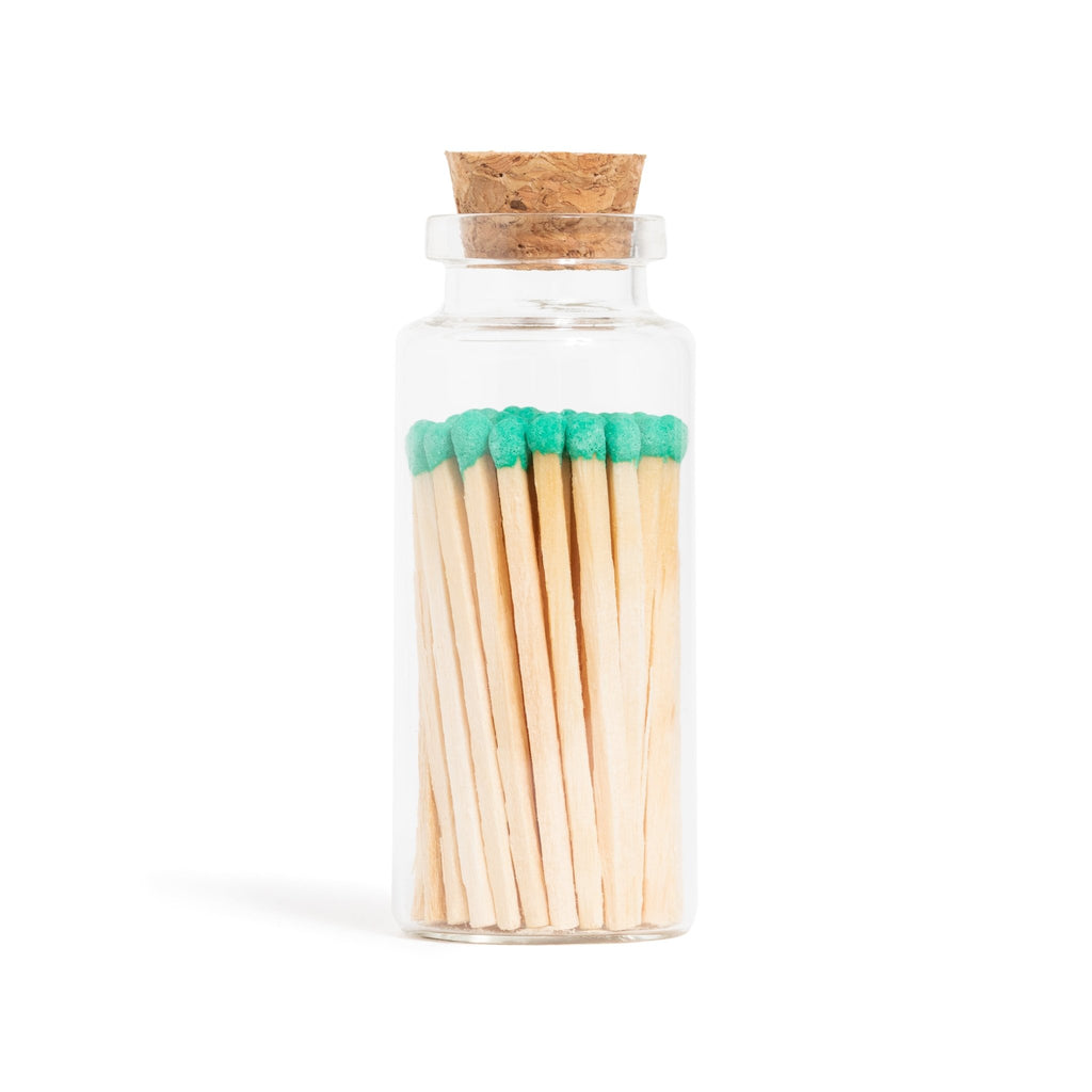 emerald green color tip wood matchsticks in corked jar with match striker