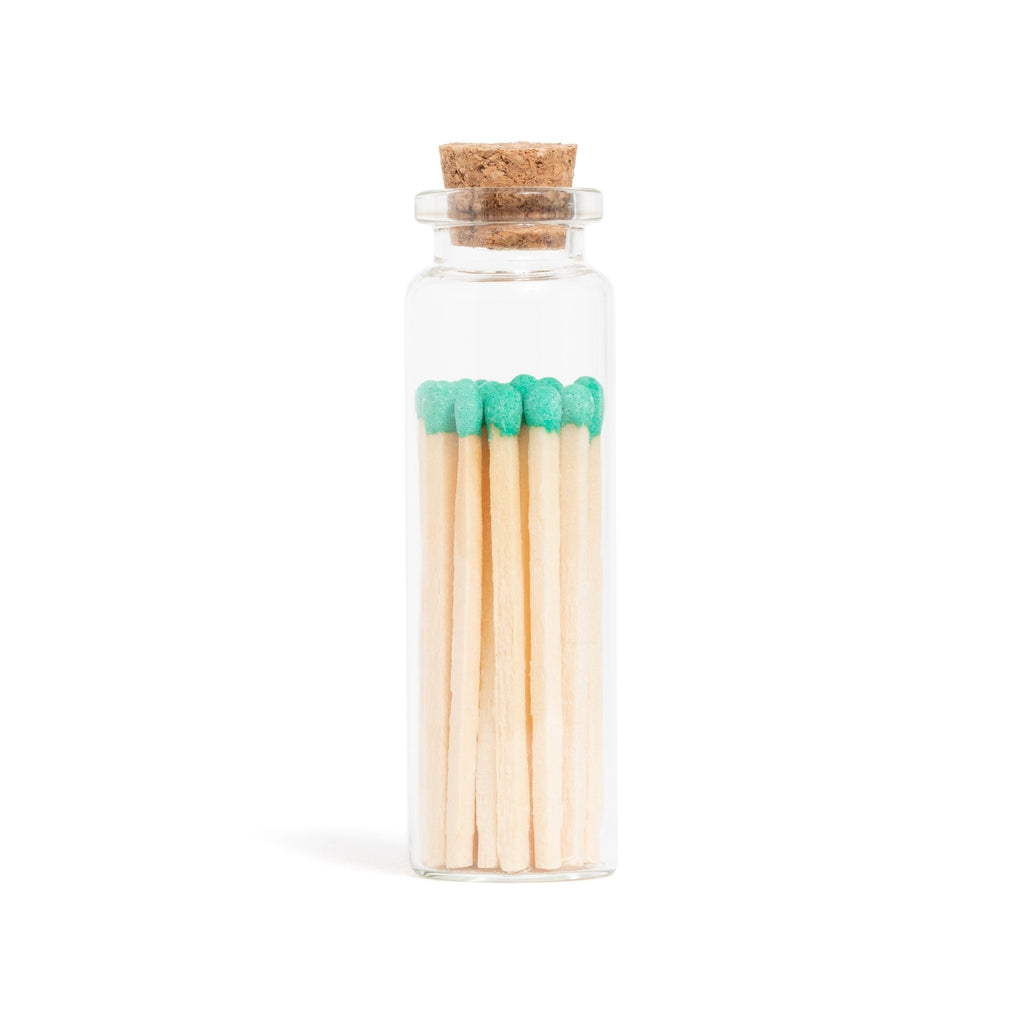 emerald green color tip wood matchsticks in corked jar with match striker