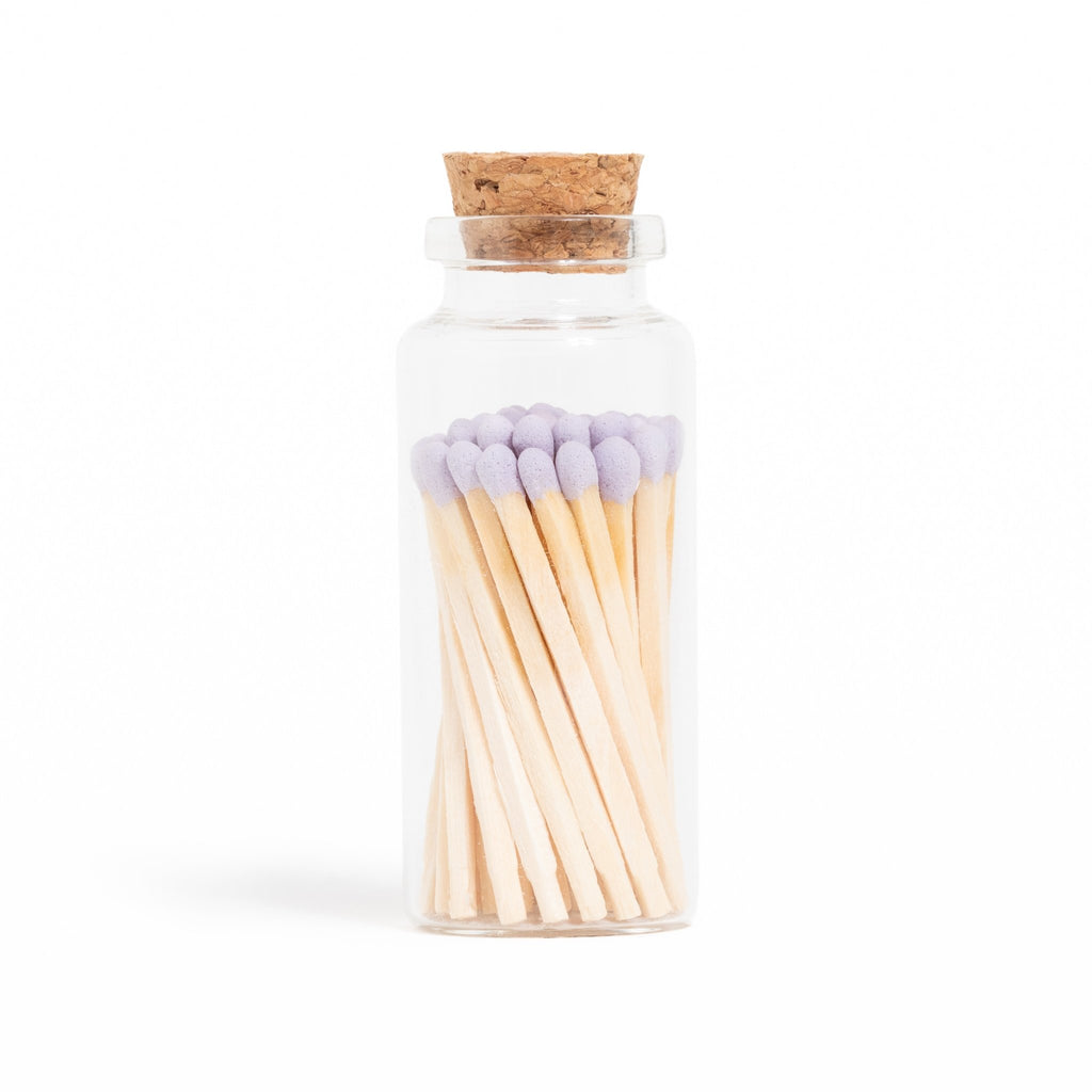 lavender color tip wood matchsticks in corked jar with match striker
