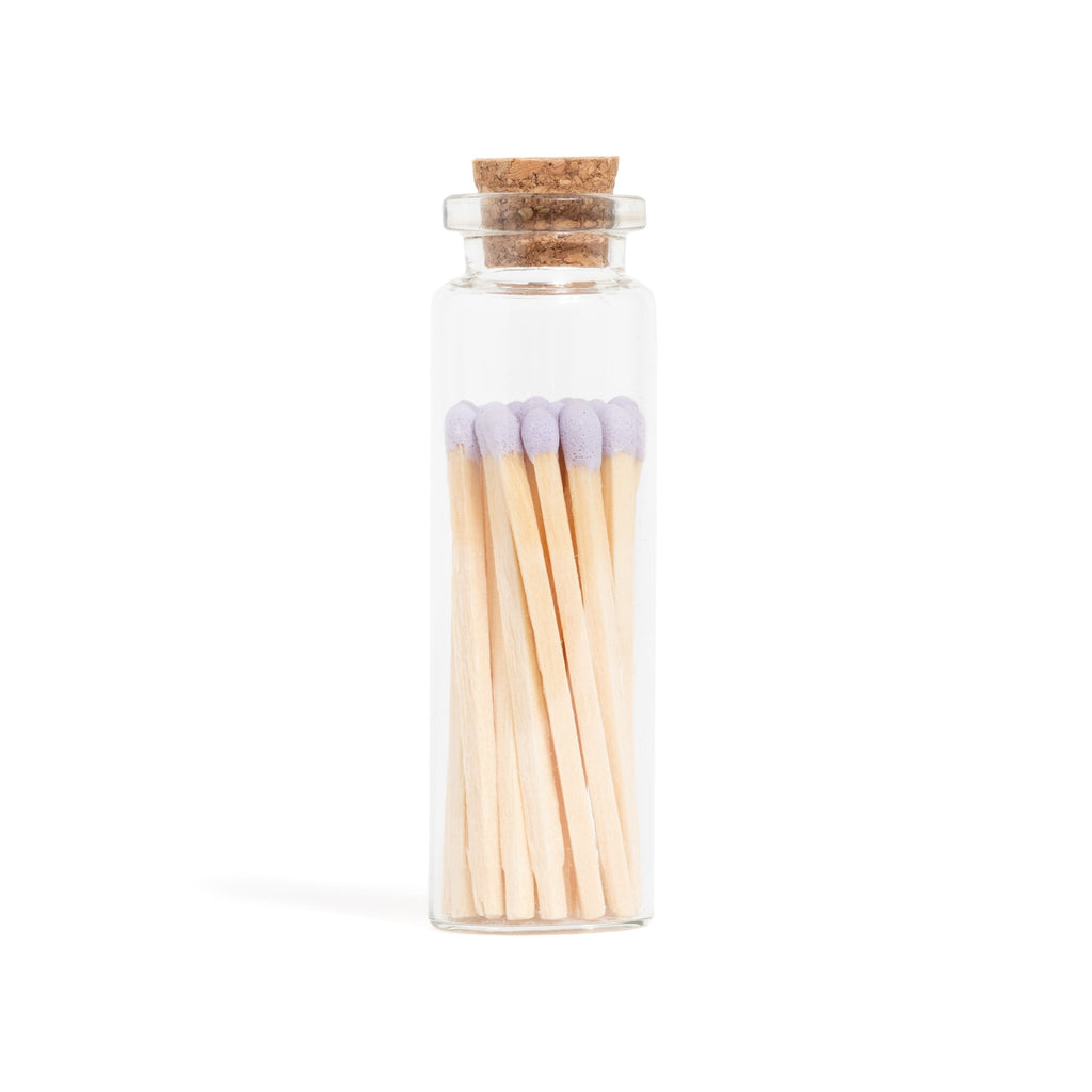 lavender color tip wood matchsticks in corked jar with match striker