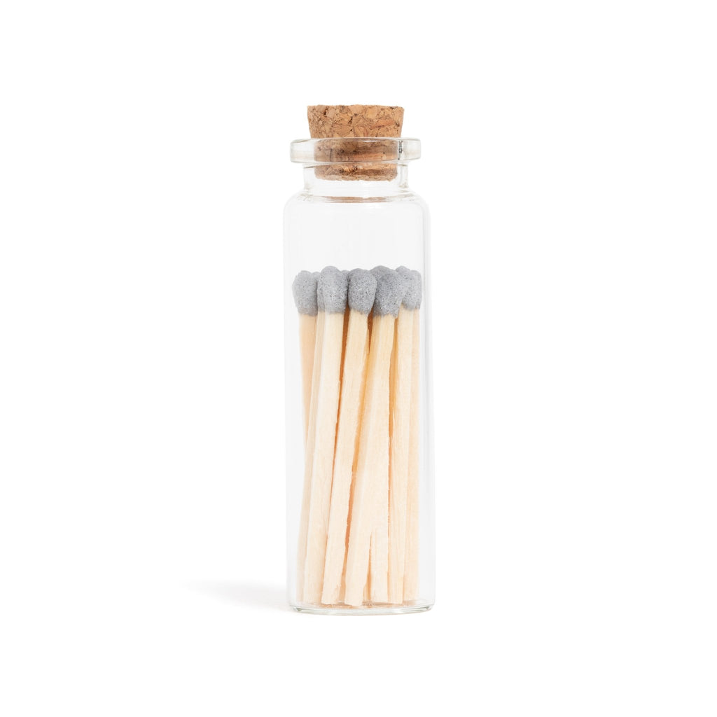 grey color tip wood matches in corked jar with match striker