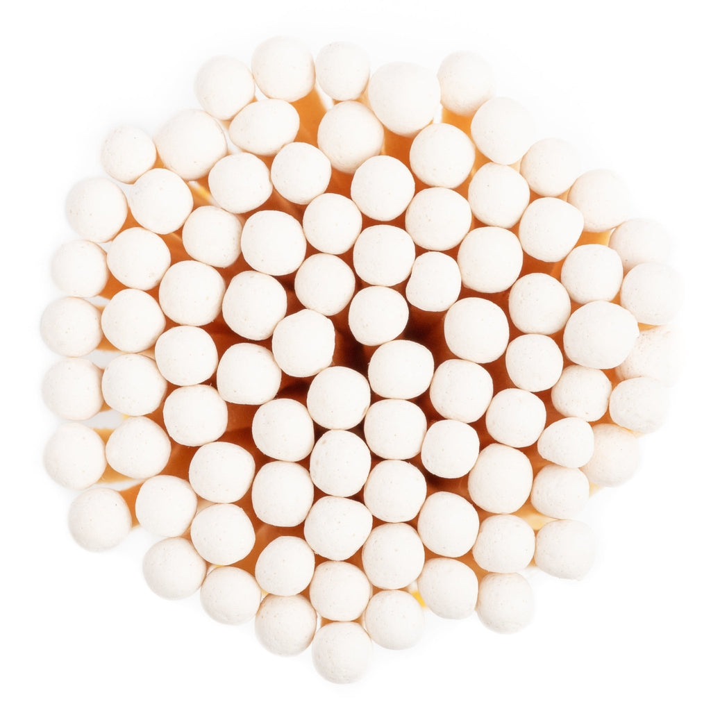 white concrete match jar with colorful matchsticks and match striker